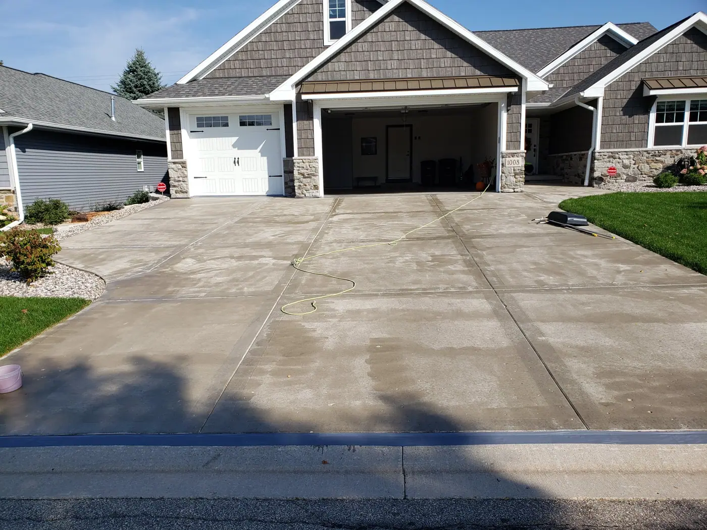 Worn concrete driveway before restoration