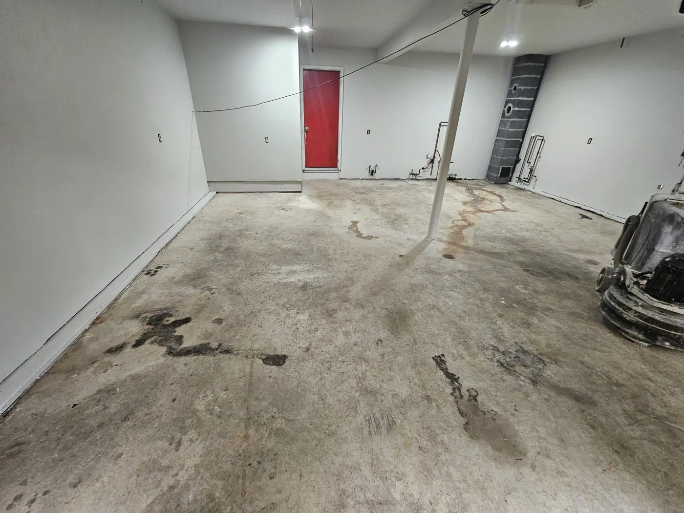 Stained, worn garage floor before coating
