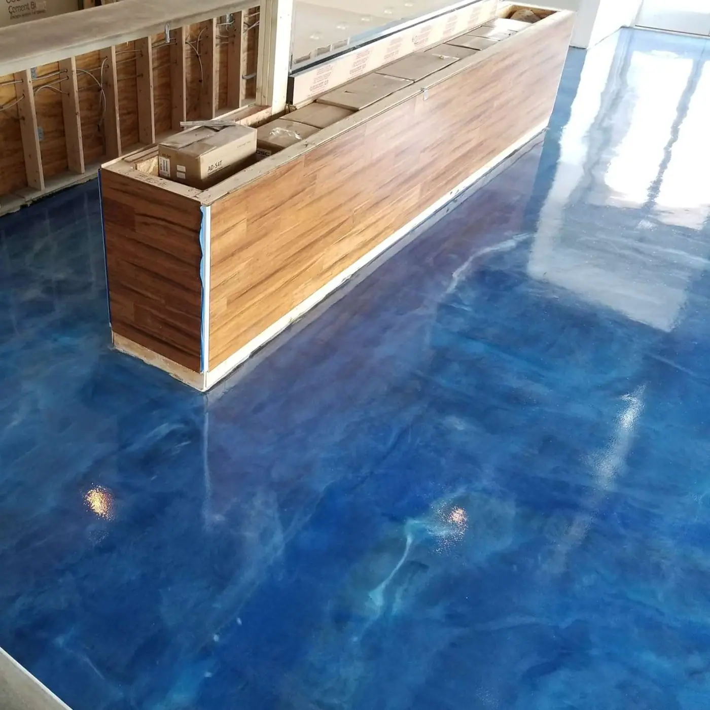 Blue metallic floor with a wood bar