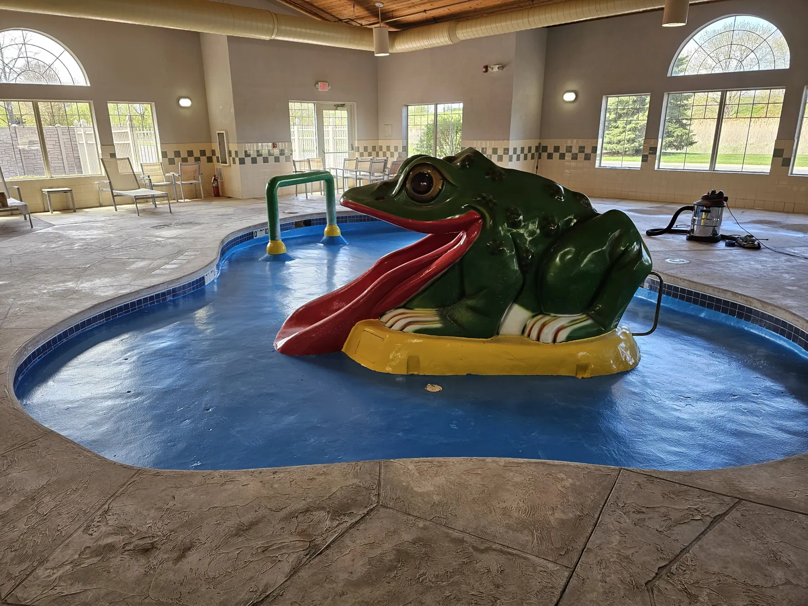 Kids splash pool with a frog slide after a DC Coatings pool coating at the Comfort Inn hotel